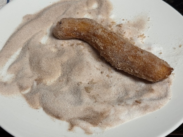 Churro roulé dans le mélange