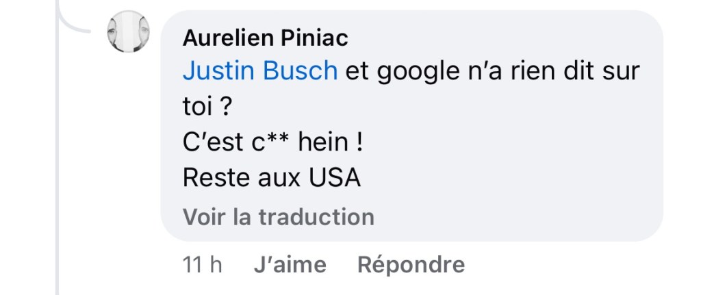 Capture d'écran d'un commentaire : Justin Busch, et Google n'a rien dit sur toi ? C'est c** hein ! Reste aux USA »