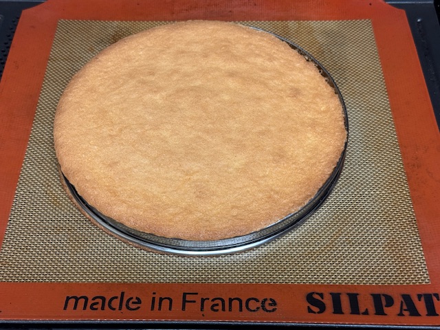 Cercle sorti du four avec une génoise cuite au-dedans