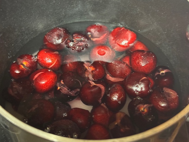 Cerises, eau et sucre dans la casserole