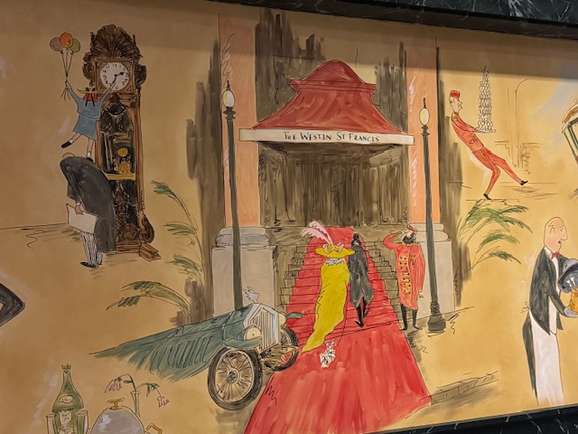 Fresque avec des dessins des clients à l'entrée à, dont dès chiens qui semblent être aussi des clients