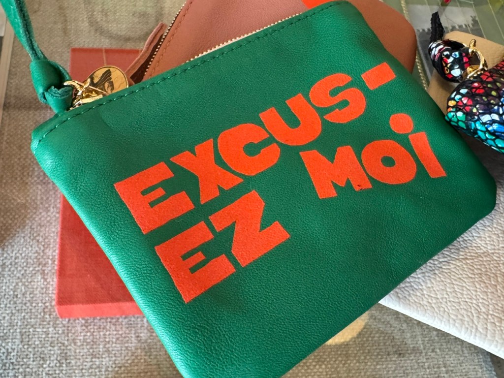 Portefeuille vert avec des lettres orange qui disent « Excusez-moi »