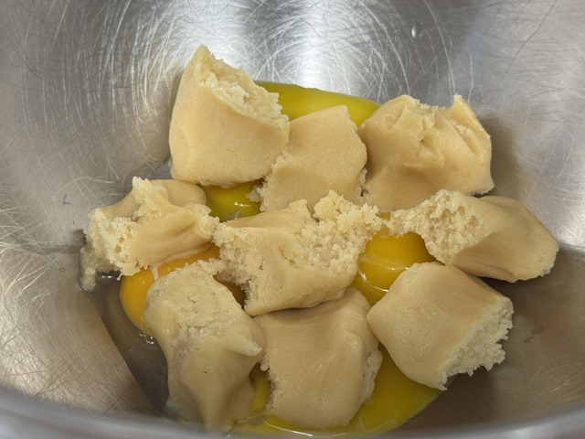 Jaunes et morceaux de pâte d'amande dans le bain-marie